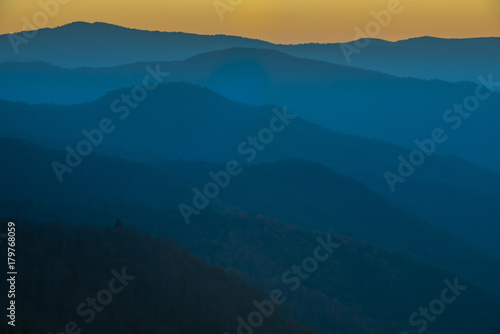 Glorious Sunrise over the Great Smoky Mountains layered blue ridges to the orange yellow horizon © Condor 36