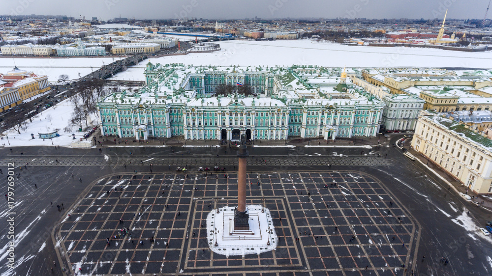 Aerial front view at the Winter Palace building, exterior with Palace Square and Aleksandr Column at winter season. Saint-Petersburg, Russia