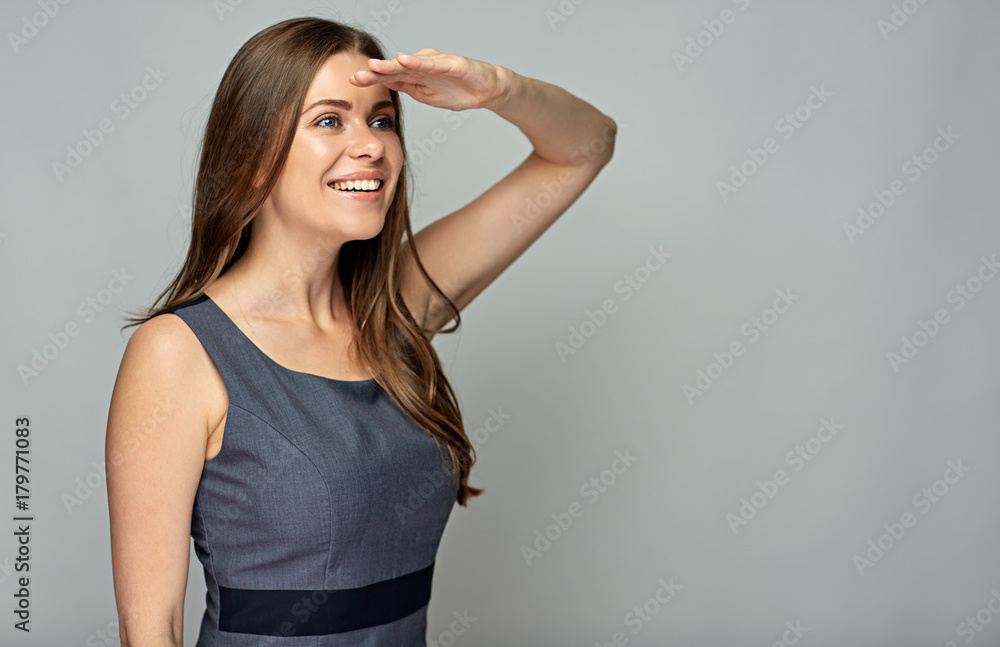 Smiling business woman looking with hand near forehead. Smiling business woman looking with hand near forehead.
