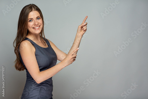 Smiling businesswoman pointing at copy space.