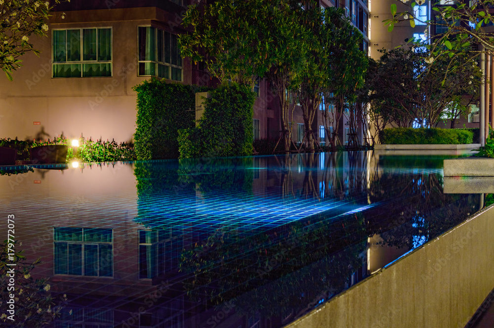 Courtyard of an apartment house with shallow blue pool