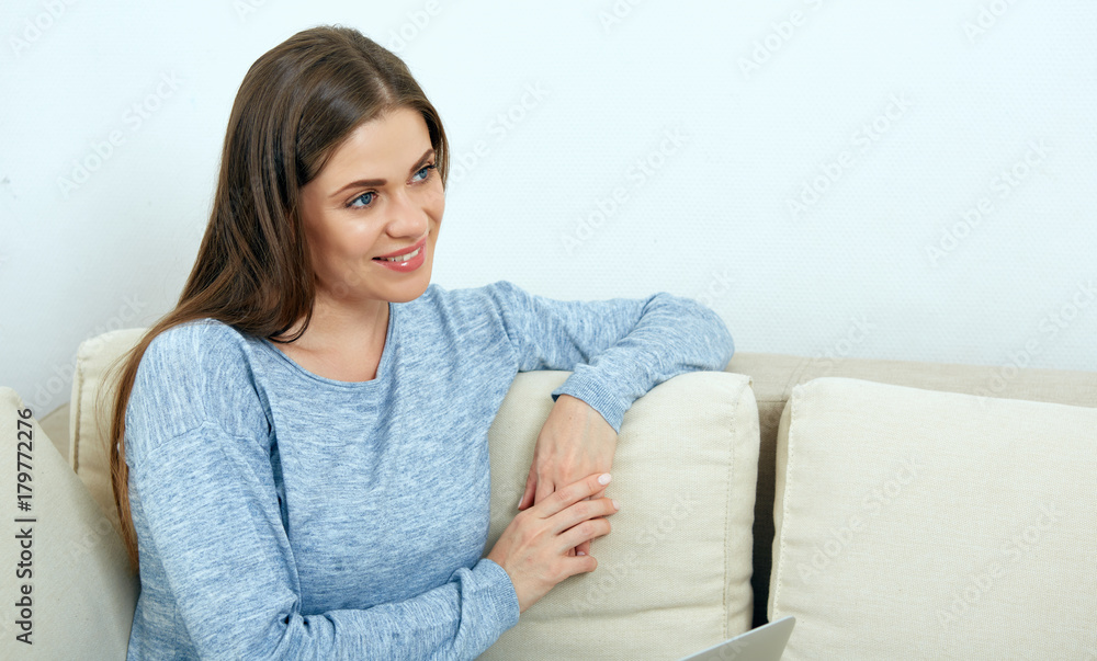 Smiling woman relaxing on sofa at home. Smiling woman relaxing on sofa at home.