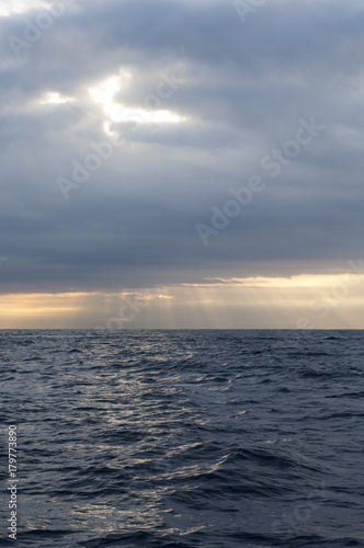 Clouds and God light over at sea