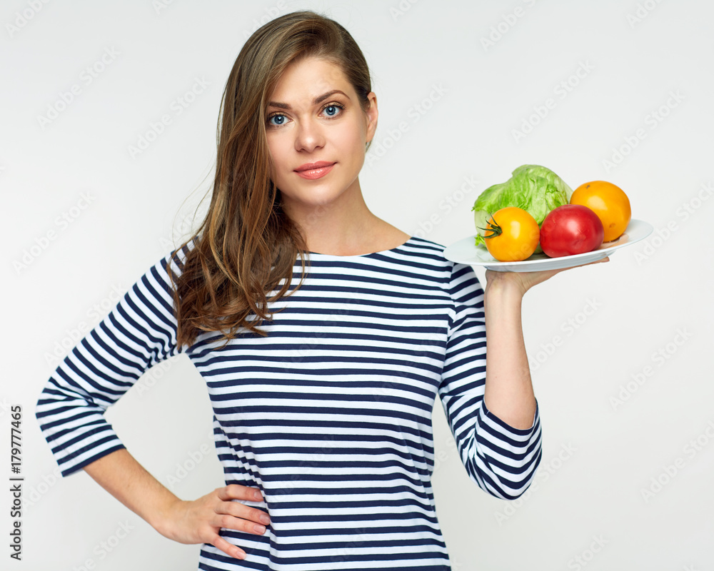 Beautiful woman holding plate with vegetables. Beautiful woman holding plate with vegetables.
