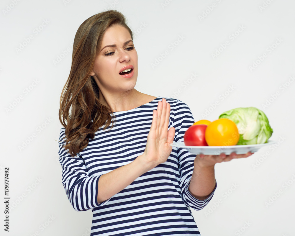 Girl refuses to eat vegetables. Isolated portrait. Girl refuses to eat vegetables. Isolated portrait.