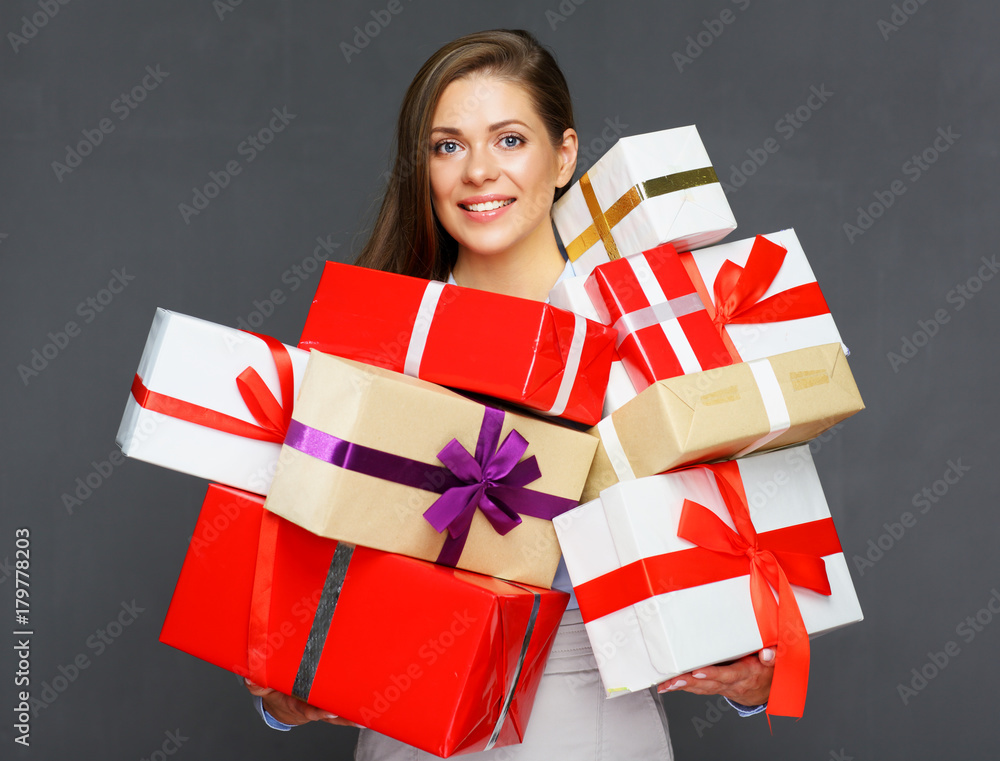 Smiling woman holding big pile of presents. Smiling woman holding big pile of presents.