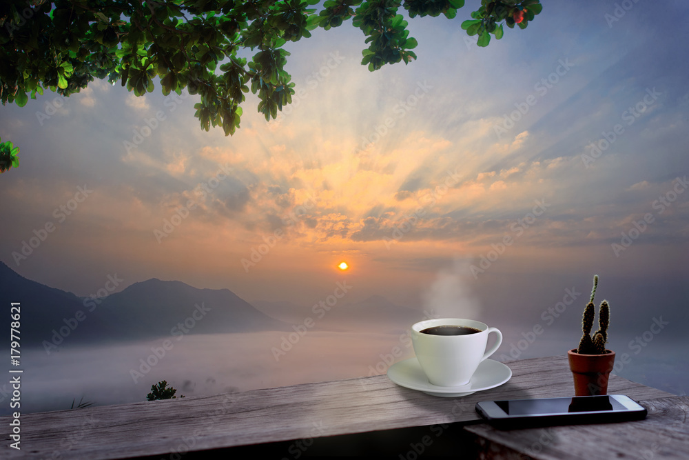regular hot black coffee tea on the resting of terrace takes with the wonderful morning with cold season of mist flowing in background