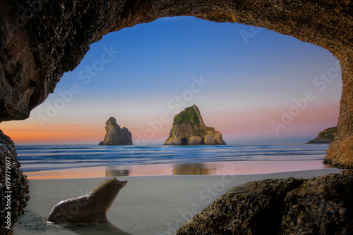 view from the cave of wharariki beach landmark of popular tourist place in south new zealand, tasman sea, nature keep always clean and original with seal coming home to the cave photo