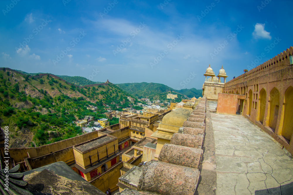 Beautiful view of Amber Fort landscape and some rooftops of the buildings, near Jaipur in Rajasthan, India. Amber Fort is the main tourist attraction in the Jaipur area, fish eye effect