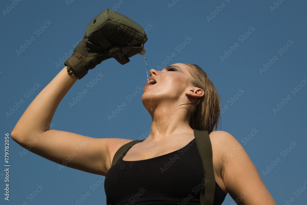Girl in uniform eagerly drinks water from the flask Girl in uniform eagerly drinks water from the flask