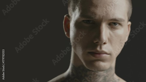 Handsome sexy young man stylish with tattoo on his neck, torso and hand - ultra close up body and face detail - greenscreen Prores - cinematic lighting