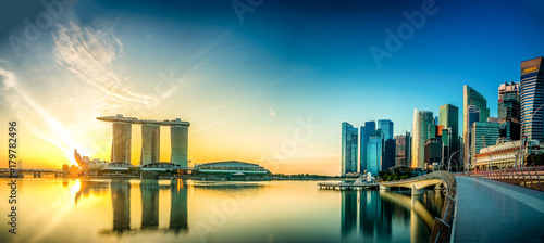 Beautiful sunrise at Marina Bay with a panoramic view of the Marina Bay Sands hotel and the skyline of the financial district in Singapore 