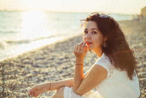 Brunette girl on the background of the sea sunset