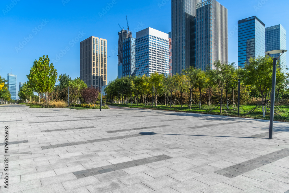 empty pavement and modern buildings in city. empty pavement and modern buildings in city.