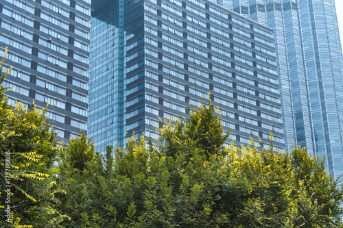 view of contemporary glass building with green trees, china.