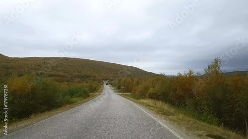 Autumn color road, Driving view of road 970 the tenontie, near tenojoki river, at the border of norway and utsjoki, on a cloudy day, in Lapland, Finland photo