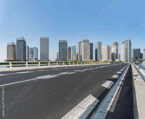 road through the bridge with city skyline background