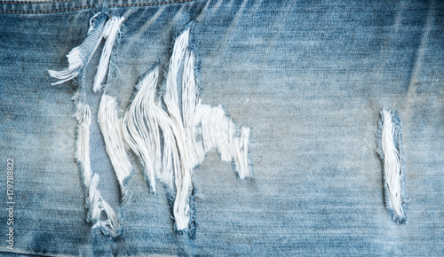 torn old blue jeans texture background