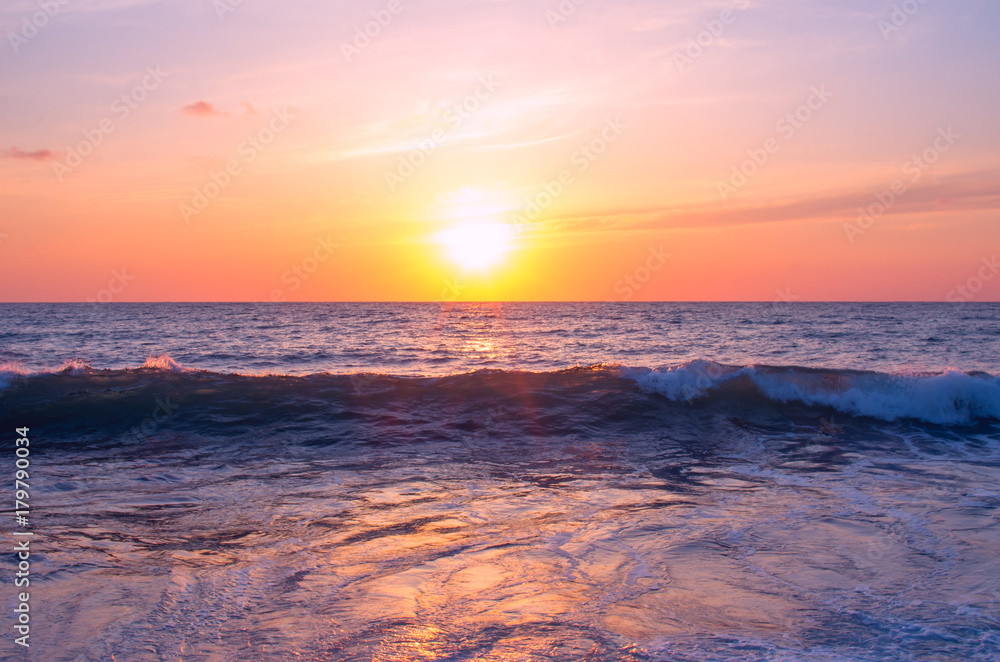 A photo of a sea wave at sunset for wallpaper on the computer desktop.