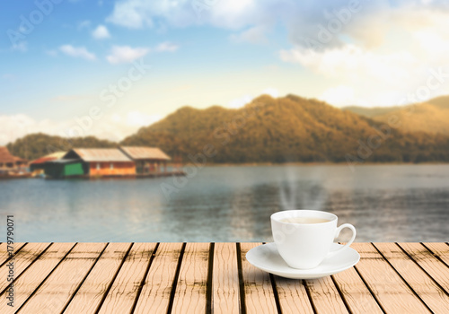 Cup of tea on wooden table on the viewpoint mountain landscape