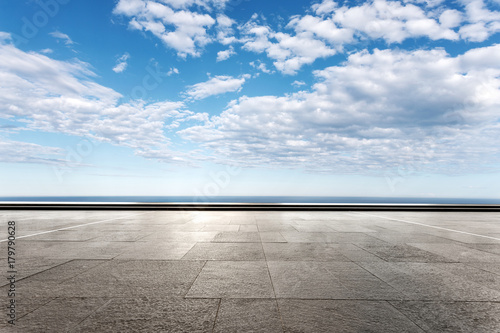empty marble floor with beautiful sea in blue cloud sky © zhu difeng