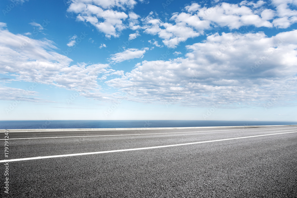 empty asphalt road with blue sea in blue sky empty asphalt road with blue sea in blue sky