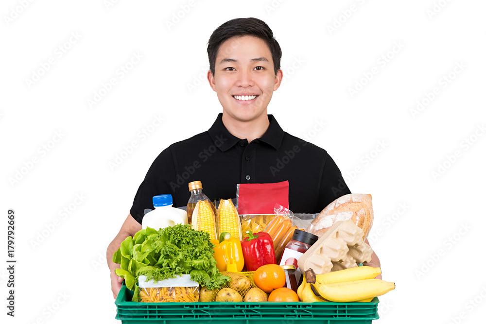 Smiling handsome grocery store Asian delivery man holding food basket isolated on white background Smiling handsome grocery store Asian delivery man holding food basket isolated on white background