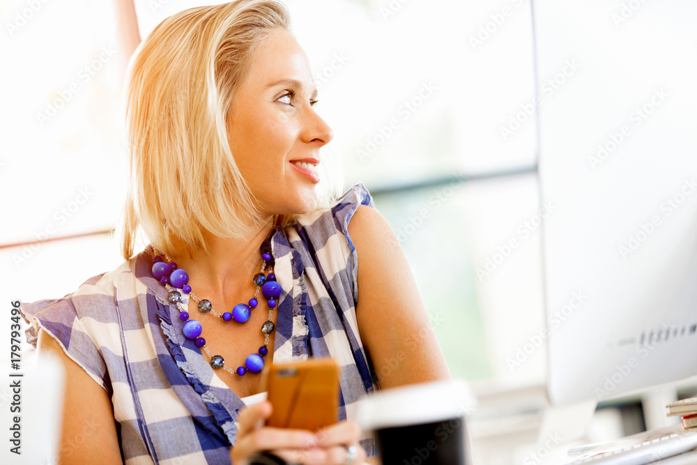 Businesswoman with mobile phone in office Businesswoman with mobile phone in office