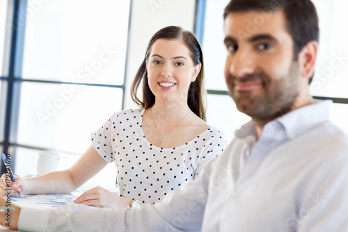 Image of two young business people in office