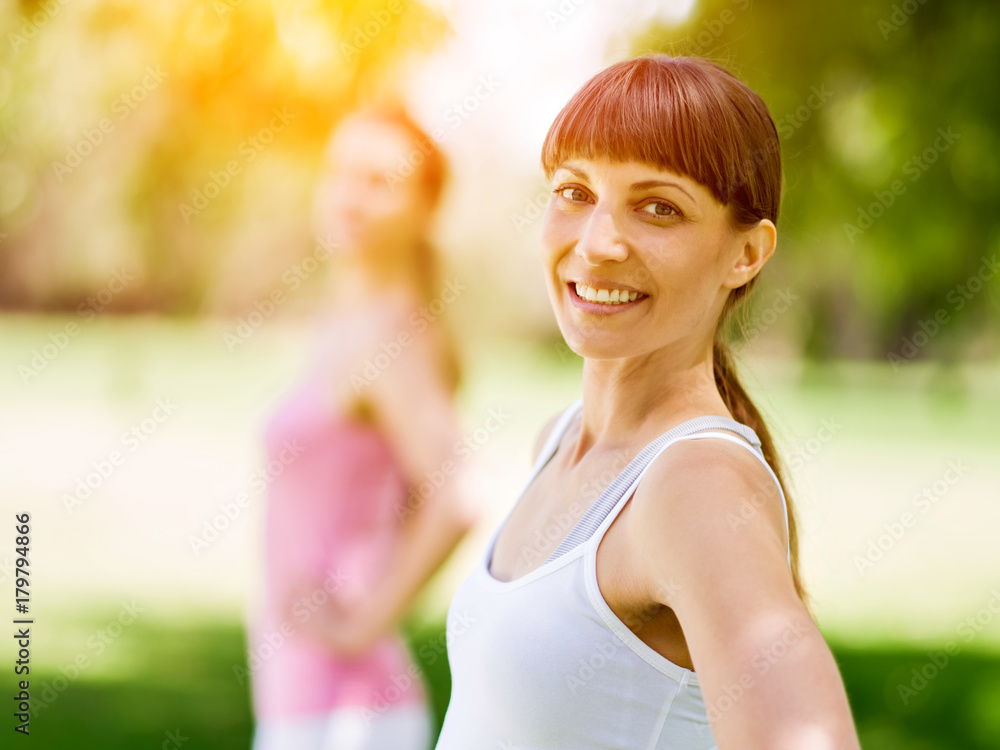 Young women exercising in the park Young women exercising in the park