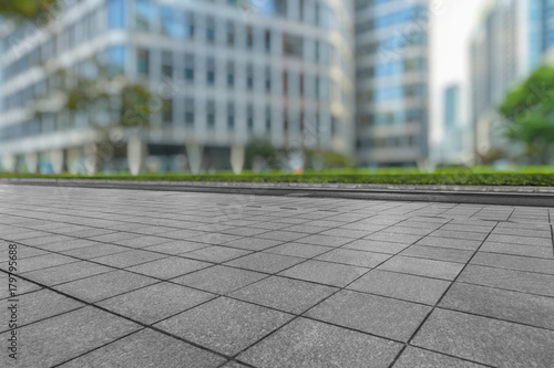 empty brick floor front of modern buildings