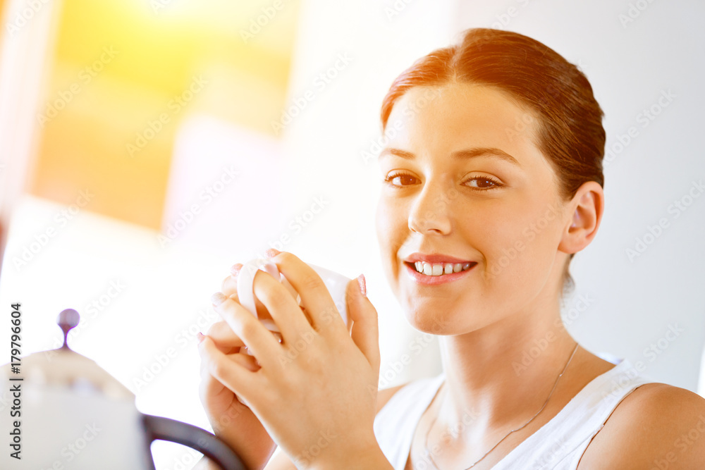 Happy young woman with cup of tea or coffee at home Happy young woman with cup of tea or coffee at home