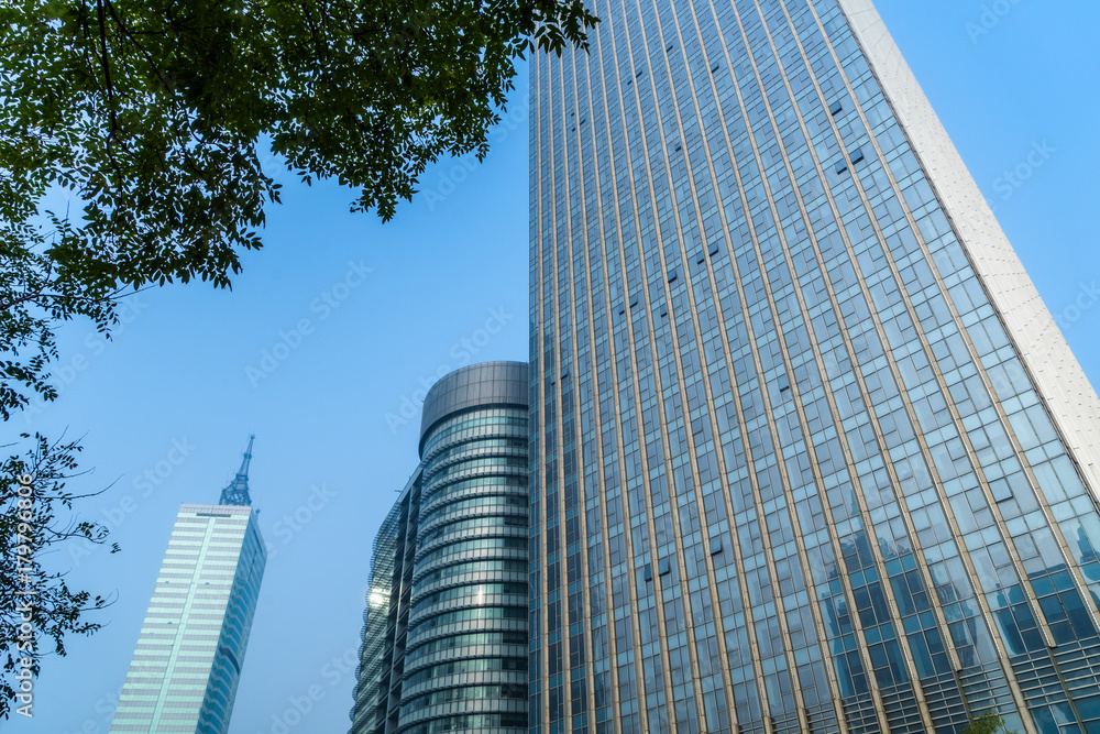 view of contemporary glass building with green leaves, china.