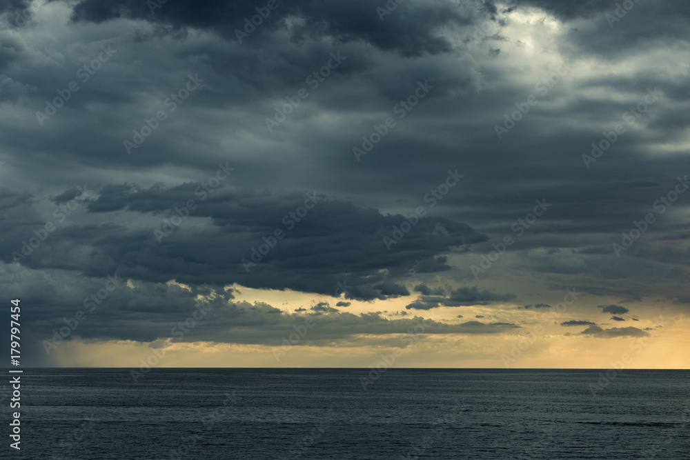 Storm clouds over sea before sunset