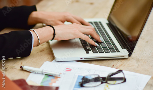 business women hand typing on laptop keyboard, network communication or finance concept.