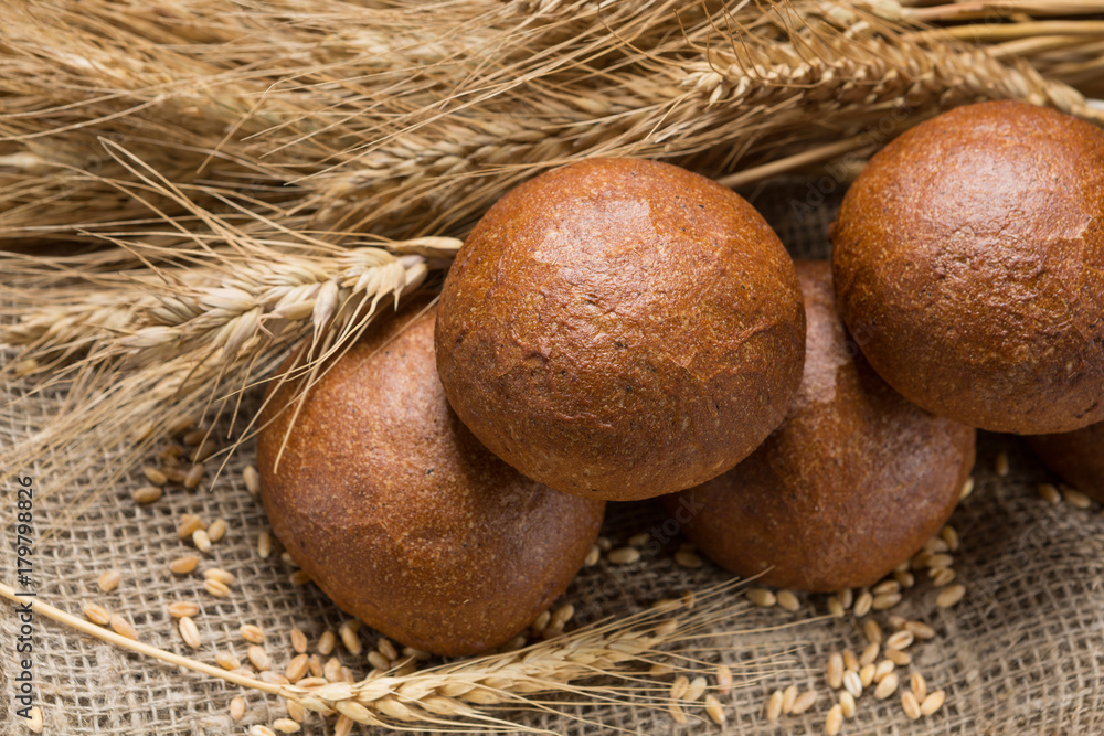five buns lined up in a sackcloth, in the background wheat ears five buns lined up in a sackcloth, in the background wheat ears