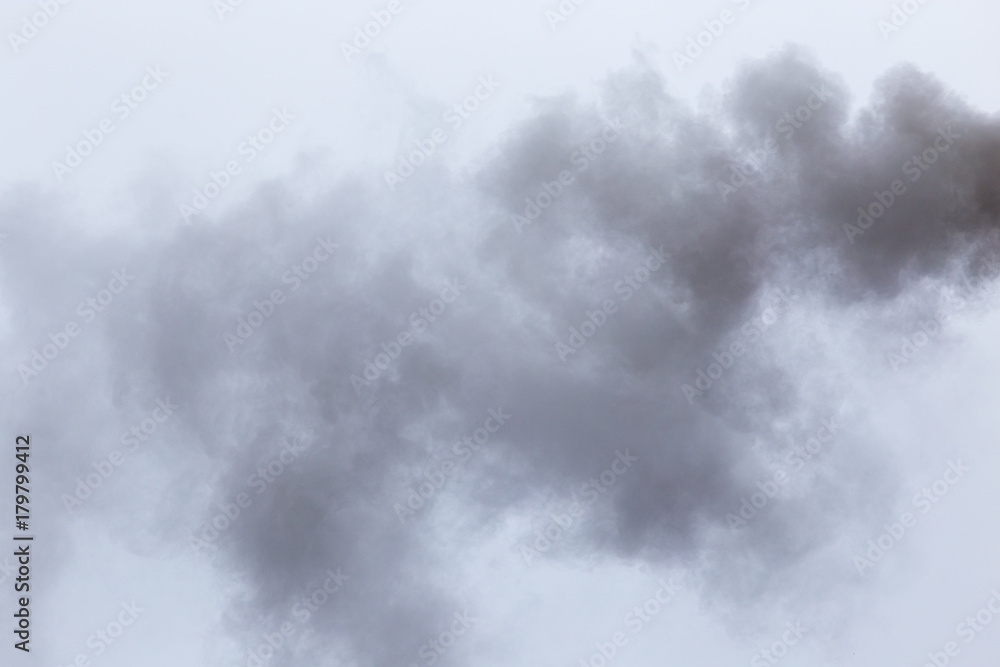 Smoke from a pipe on a cloudy sky