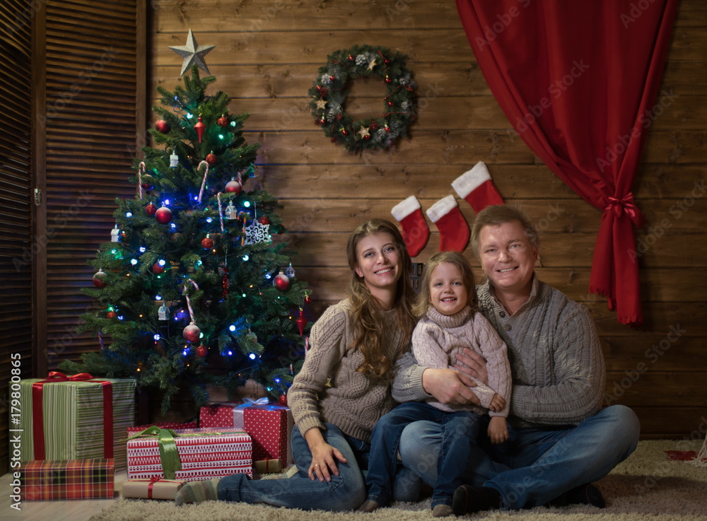 Happy family celebrating Christmas at home Happy family celebrating Christmas at home