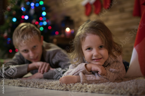 Two children near a Christmas tree