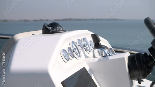Detail of analogical and digital instruments on the cockpit of a yacht.