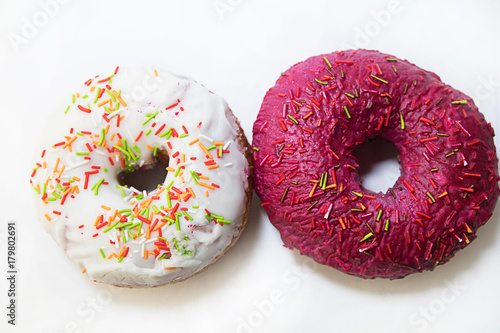 two donuts covered with red glaze top view on white background