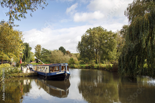 Narrow boat moored on the Avon canal awaiting tourists to cruise down the river through Stratford upon Avon photo