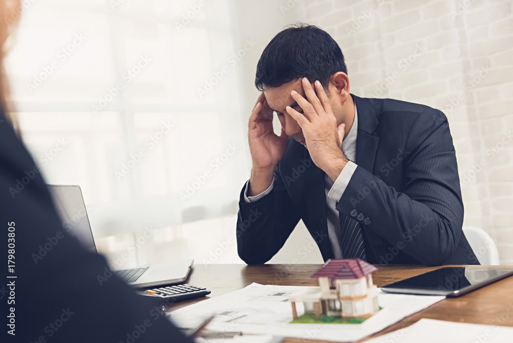 Asian investor businessman getting stressed about real estate finance Asian investor businessman getting stressed about real estate finance