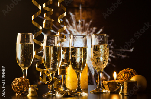 champagne glasses against holiday lights ready for New Year's eve party