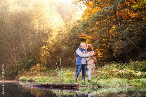 Senior couple on a walk in autumn nature. © Halfpoint