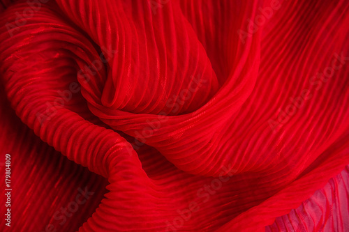 The texture of the pleated fabric. Red georgette fabrics.