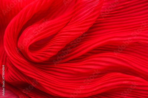 Embossed fabric, pleated. Red material textile. photo