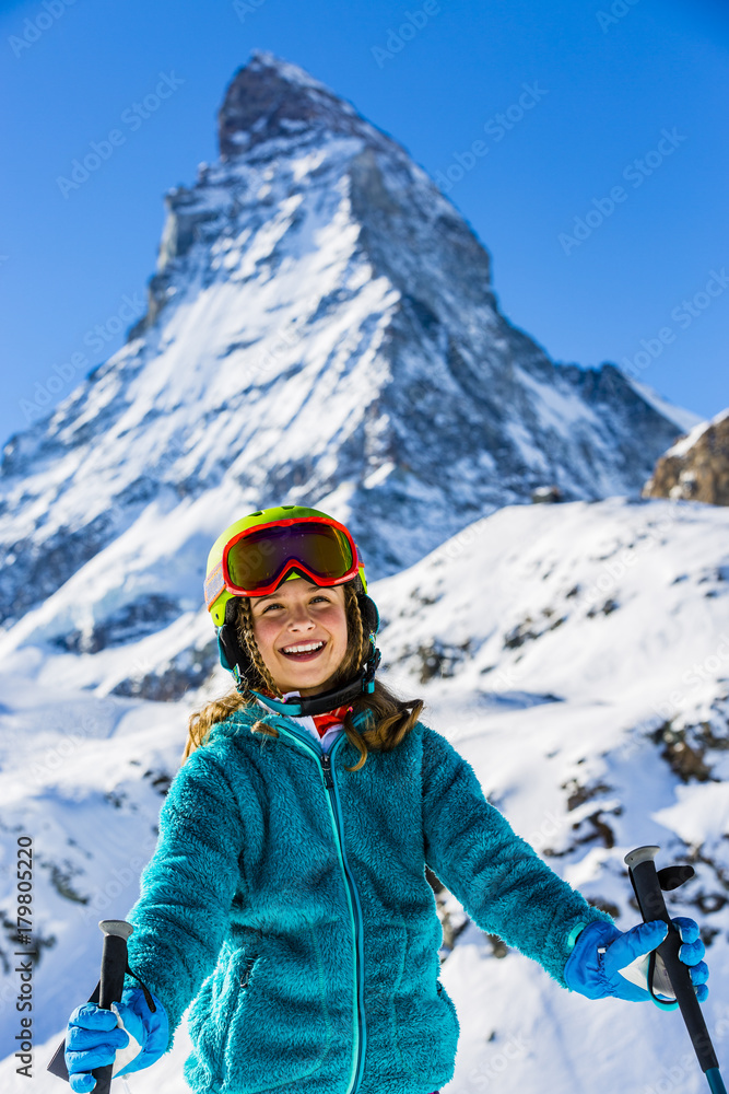 Girl on skiing on snow on a sunny day in the mountains. Ski in winter seasonon, the tops of snowy mountains in sunny day. South Tirol, Solda in Italy.