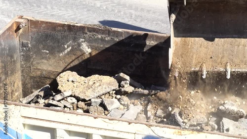 Dump truck being loaded with soil by shovel. Construction machinery working at the construction site