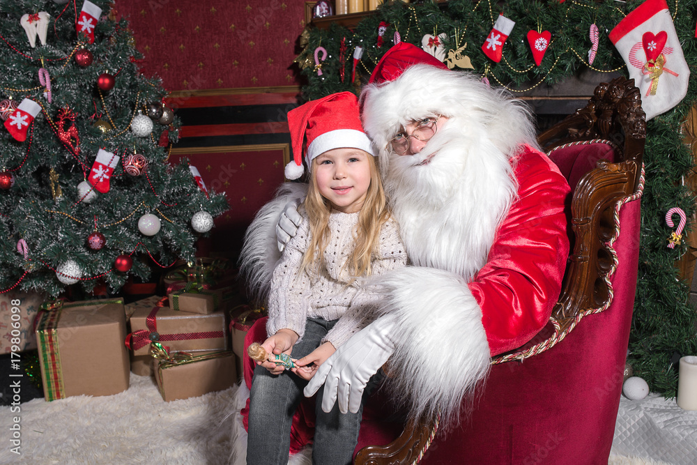 Santa Claus and cute girl getting ready for Christmas. Santa Claus and cute girl getting ready for Christmas.
